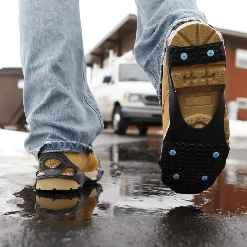 Walking across a wet parking lot in DueNorth All Purpose traction aids