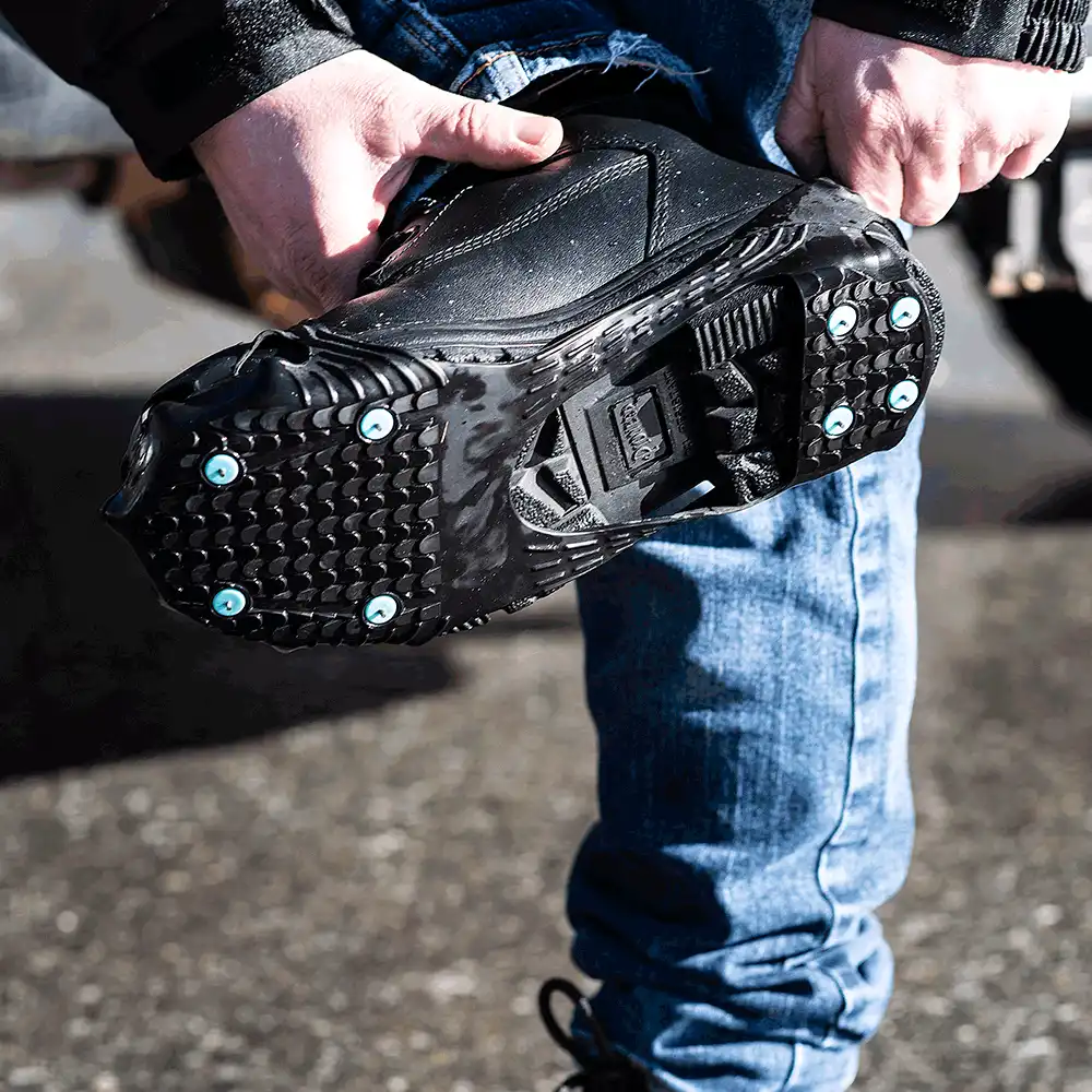 Pulling a DueNorth traction aid onto a work boot