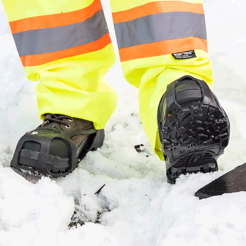Shoveling snow in DueNorth Heavy Duty traction aids